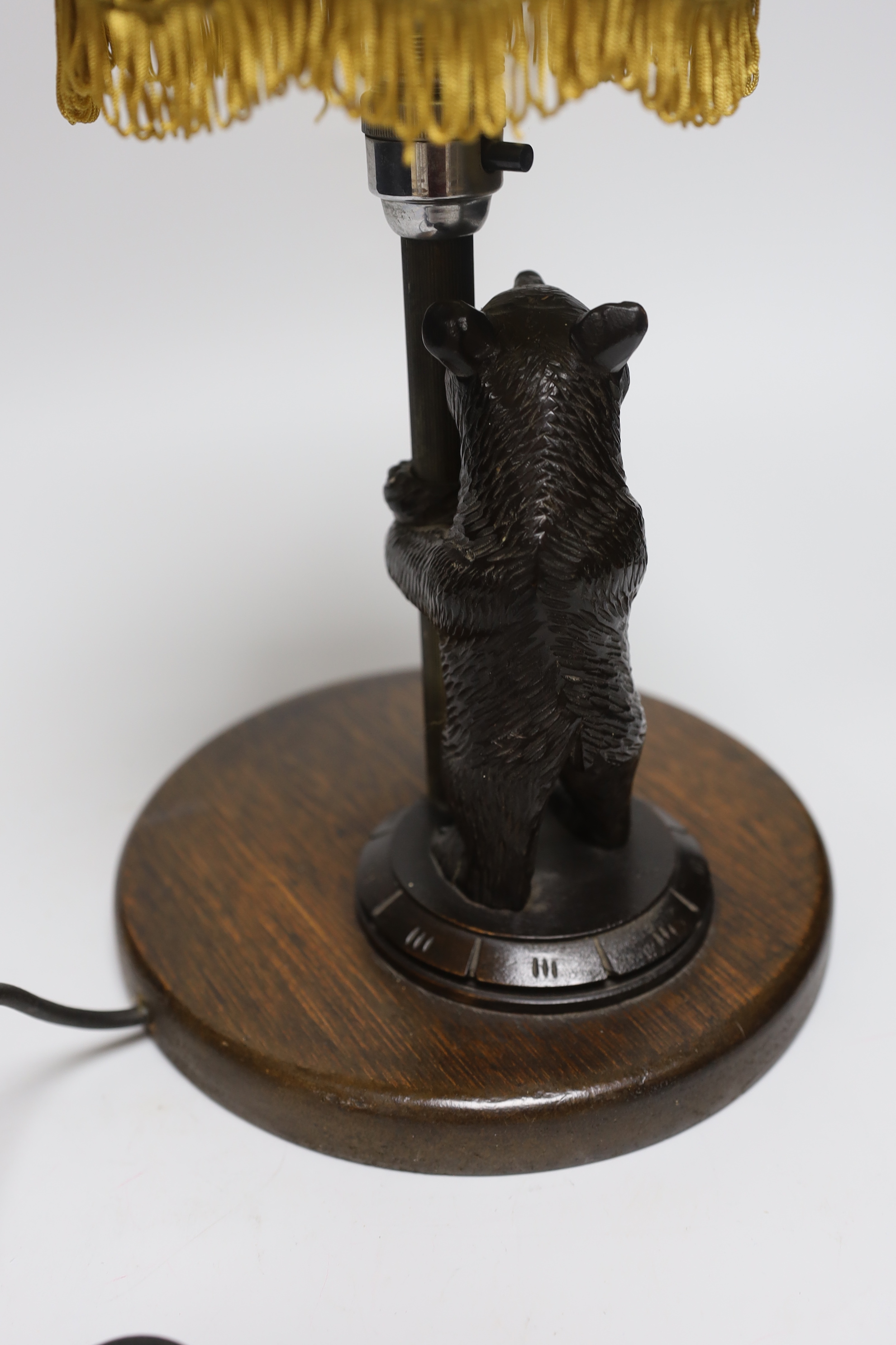 A Black Forest 'bear' table lamp, 36cm including shade